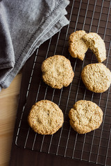 Gluten free homemade oatmeal cookies and napkin on cooling rack. Vertical. Selective focus
