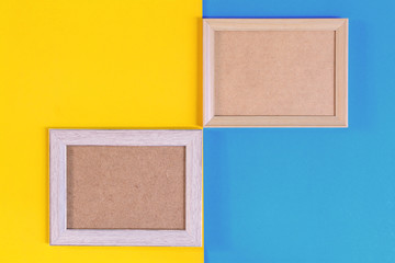 Fototapeta premium Photo wood frame on colorful paper wall background