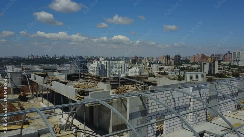 Poster aerial view of construction site and group of builders working together, team of engineers on buildi