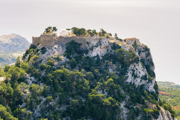 Fototapeta na wymiar Monolithos Castle sits on the summit of a sheer, rocky outcrop. Island of Rhodes, Greece