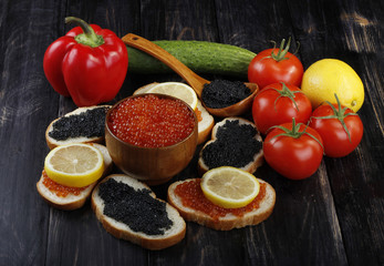 caviar and vegetables on wooden background