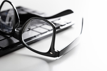 eyeglasses and keyboard on the table