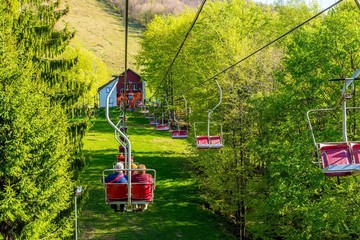 Chair lift on mountain with retired people, landscape view