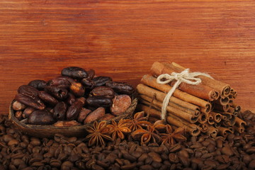 cacao, coffee and cinnamon on wooden background