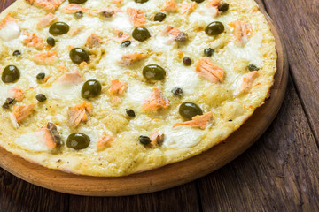 Italian seafood pizza at wood background