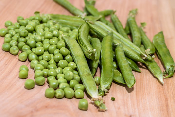 Fresh peas on a wooden board