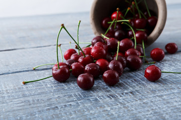 Fresh cherries closeup on blue rustic wood