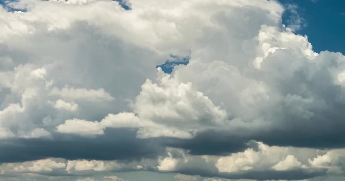 Time lapse clip of white fluffy curly rolling clouds