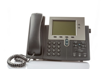 Modern IP digital phone isolated on white background with reflection. Enterprise IP voice solution concept