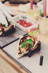 Street vendor selling taco outdoors, closeup of wrapped snacks