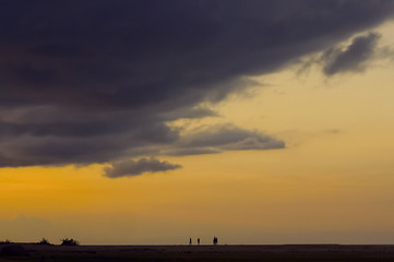 Minimalist And Silhouetted People Over Sunset