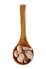 garlic in wooden spoon isolated