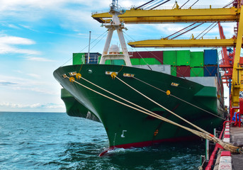 Port logistics, large container vessel berthing under many quay crane ready for unloading...