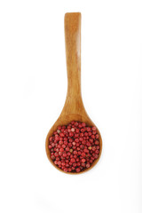 pink peppercorn in wooden spoon isolated