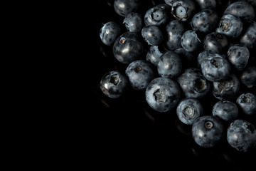 A pile of blueberries isolated on black background
