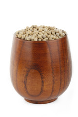 white peppercorn, in wooden cup isolated