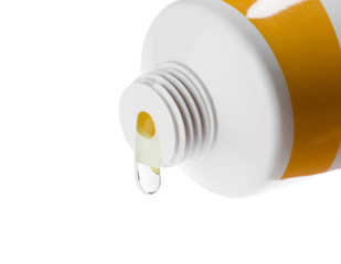 Cosmetic liquid pouring from bottle isolated on white background