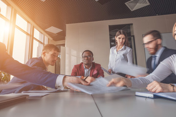 Blurred motion of businesspeople working with boss sitting in background at office