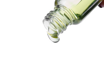 Cosmetic liquid pouring from bottle isolated on white background
