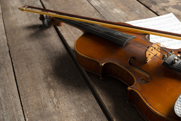 Sheet music and violin on wooden table