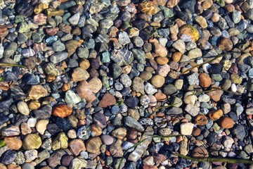Stones on sea floor under the wave