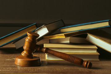 Gavel With Books On Old Wooden Desk
