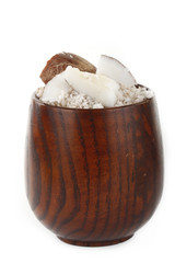 ground cococnuts in wooden cup isolated
