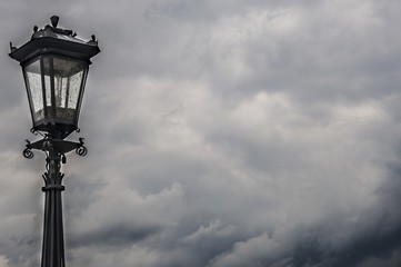 Fototapeta na wymiar an antique lamp against storm clouds
