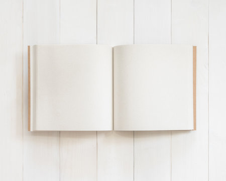 Blank book mockup open page template square-size recycle paper texture on white wood table from top view