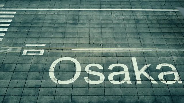 Aerial view of commercial plane landing at Osaka airport. Travel to Japan conceptual 4K intro animation