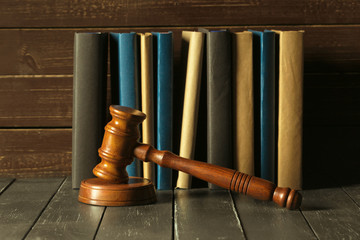 Gavel With Books On Old Wooden Desk