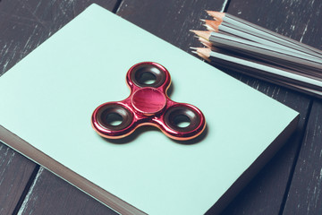 Books and spinner on the old Wooden table.