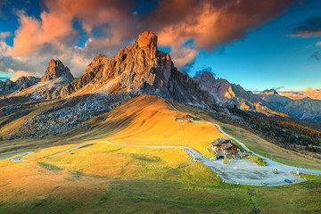 Fototapeta na wymiar Fantastic alpine pass with high peaks in background, Dolomites, Italy