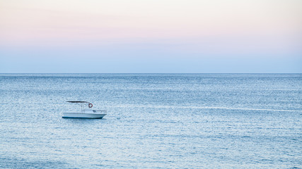 boat in sea in blue summer evening