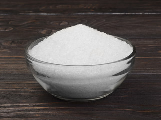 White crystals of salt in a glass bowl