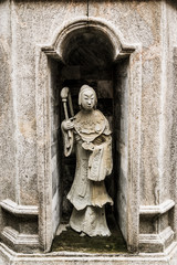 old statue in public temple in Thailand with dramatic tone