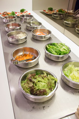 Self service salad bar with a variety of salads