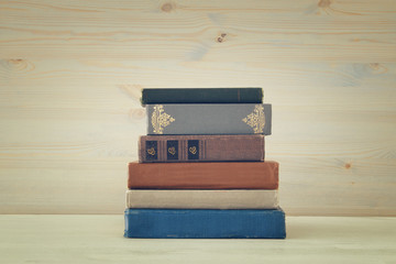 Image of old vintage books on a wooden shelf