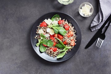 Quinoa salad with strawberry and parmesan cheese. Overhead view. Copy space