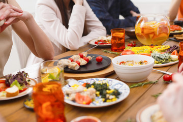 Obraz na płótnie Canvas Served table for dinner closeup, people dining
