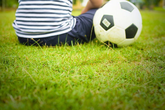 Boy with ball,Or boy with soccer and green grass(focus center of picture)