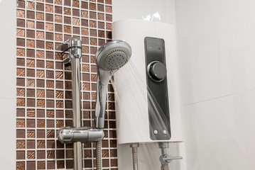 Water heater and shower spray in bathroom. Electric Water Heater Rain Shower
