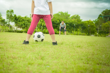 Obraz premium Boy Asian playing football with friend