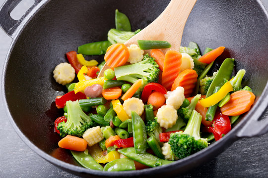 stir fried vegetables in a wok