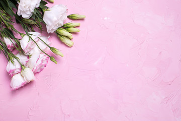 Pink and white eustoma flowers on pink  textured background.