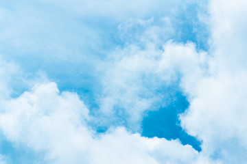 Blue sky background with tiny clouds. White fluffy clouds in the blue sky