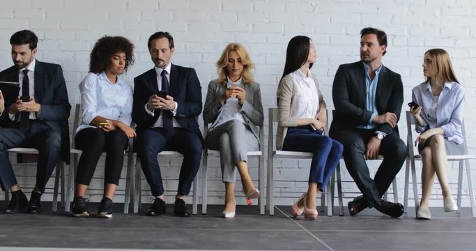 Group Of Business People Talk Using Cell Smart Phones And Other Gadgets During Conference Meeting, Businesspeople Team Surfing Internet Waiting For Conference Begining Slow Motion 60