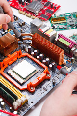 Engineer checking motherboard with multimeter