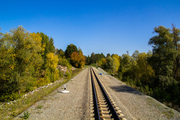 Fototapeta na wymiar Photo of a railway in the autumn forest