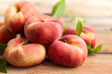 Fresh peaches on wooden table